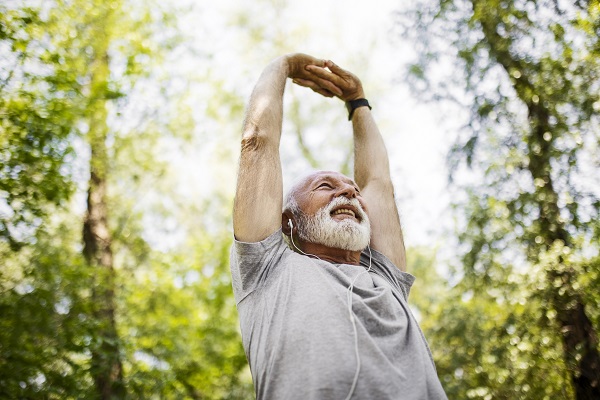 Senior man stretching after a run in the park